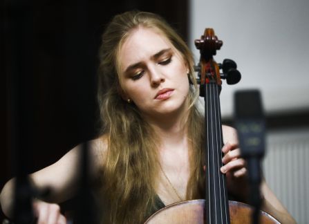 A photograph. A string concert in Villa Decius. A woman plays the cello.